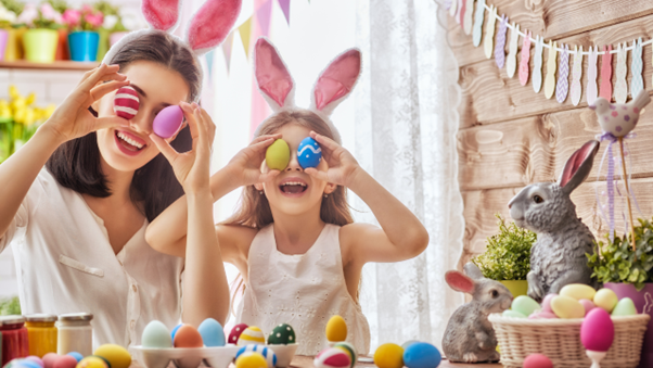 Woman and child decorating Easter eggs.